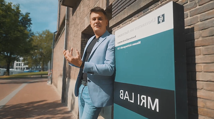 A man standing next to a sign